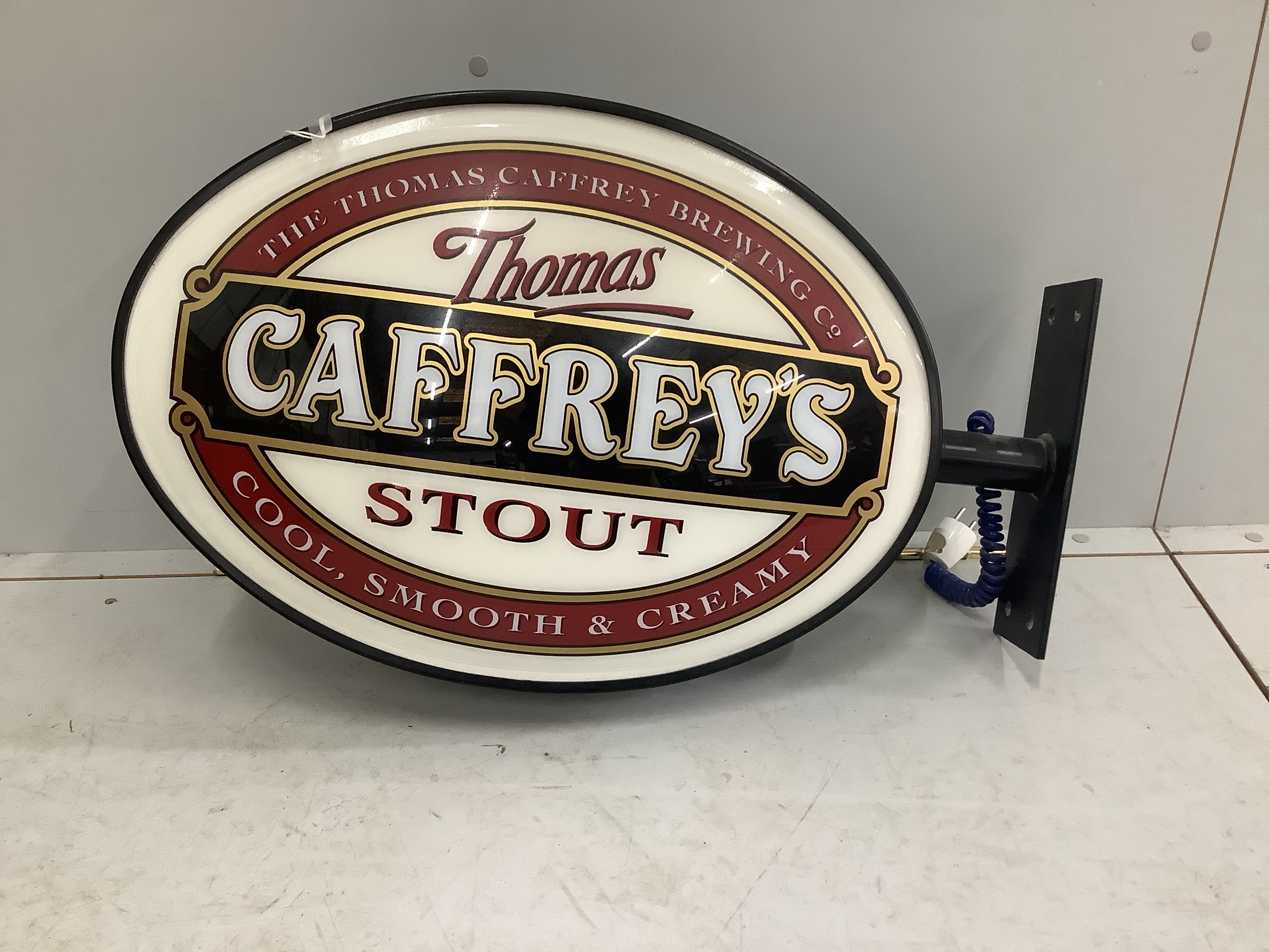 A Caffrey's illuminated double sided pub sign, width with bracket 75cm, height 46cm